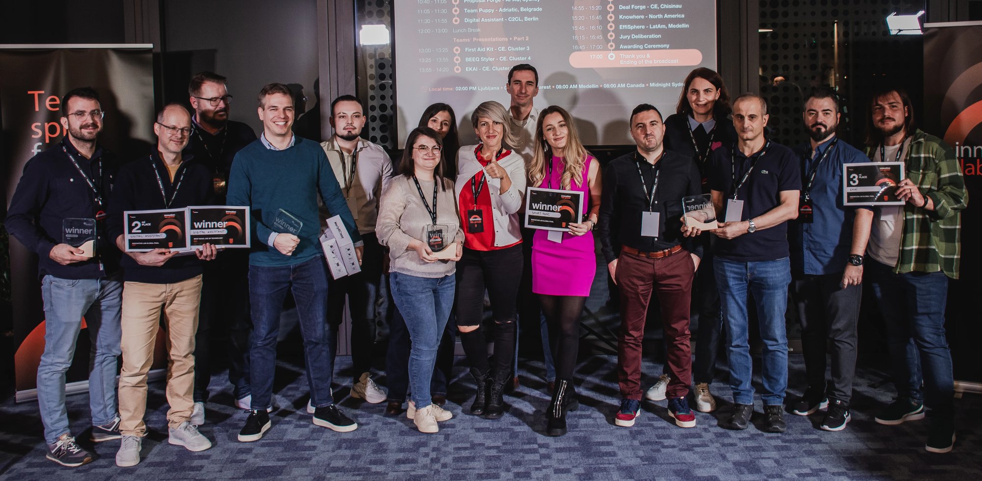 A group of people celebrating success with awards at an innovation lab