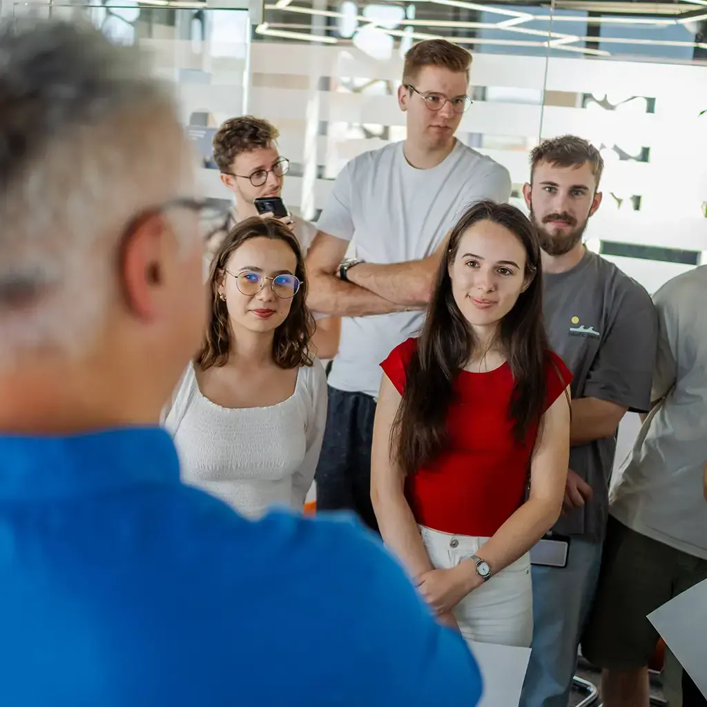 Team members attentively listening during a collaborative office meeting or project discussion.