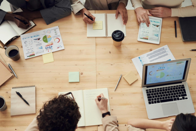 A table with notebooks and laptops in an office
