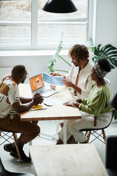 A group of colleagues checking something on a laptop