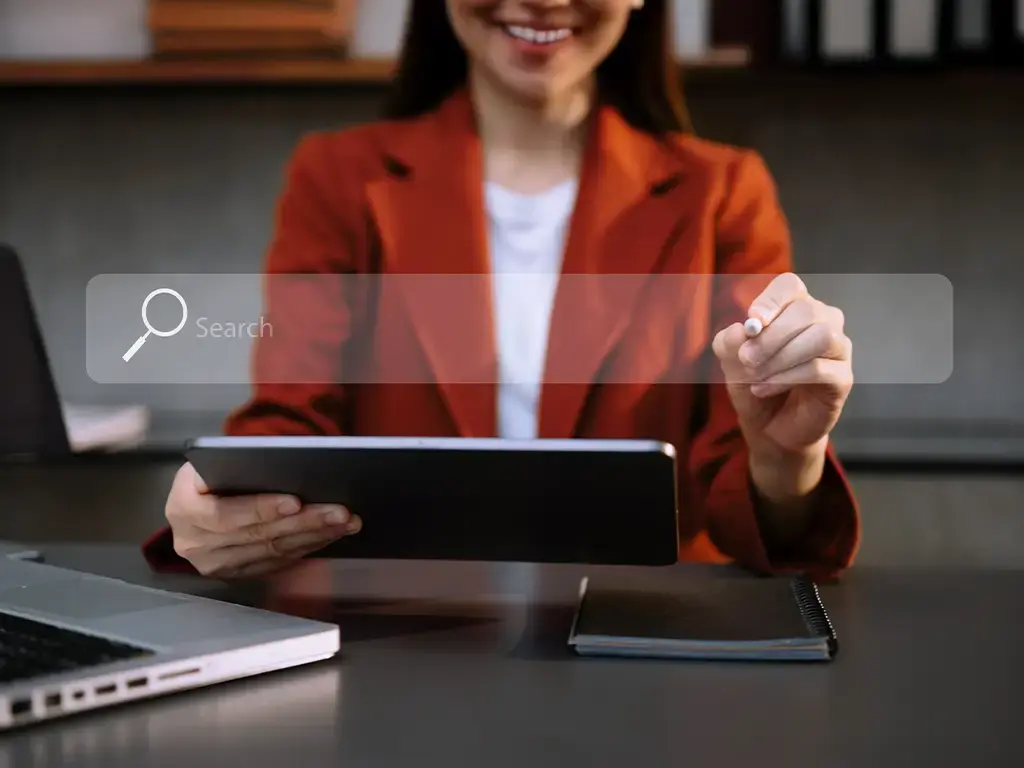 Professional using tablet and stylus with virtual search bar, representing AI-driven enterprise search in retail.