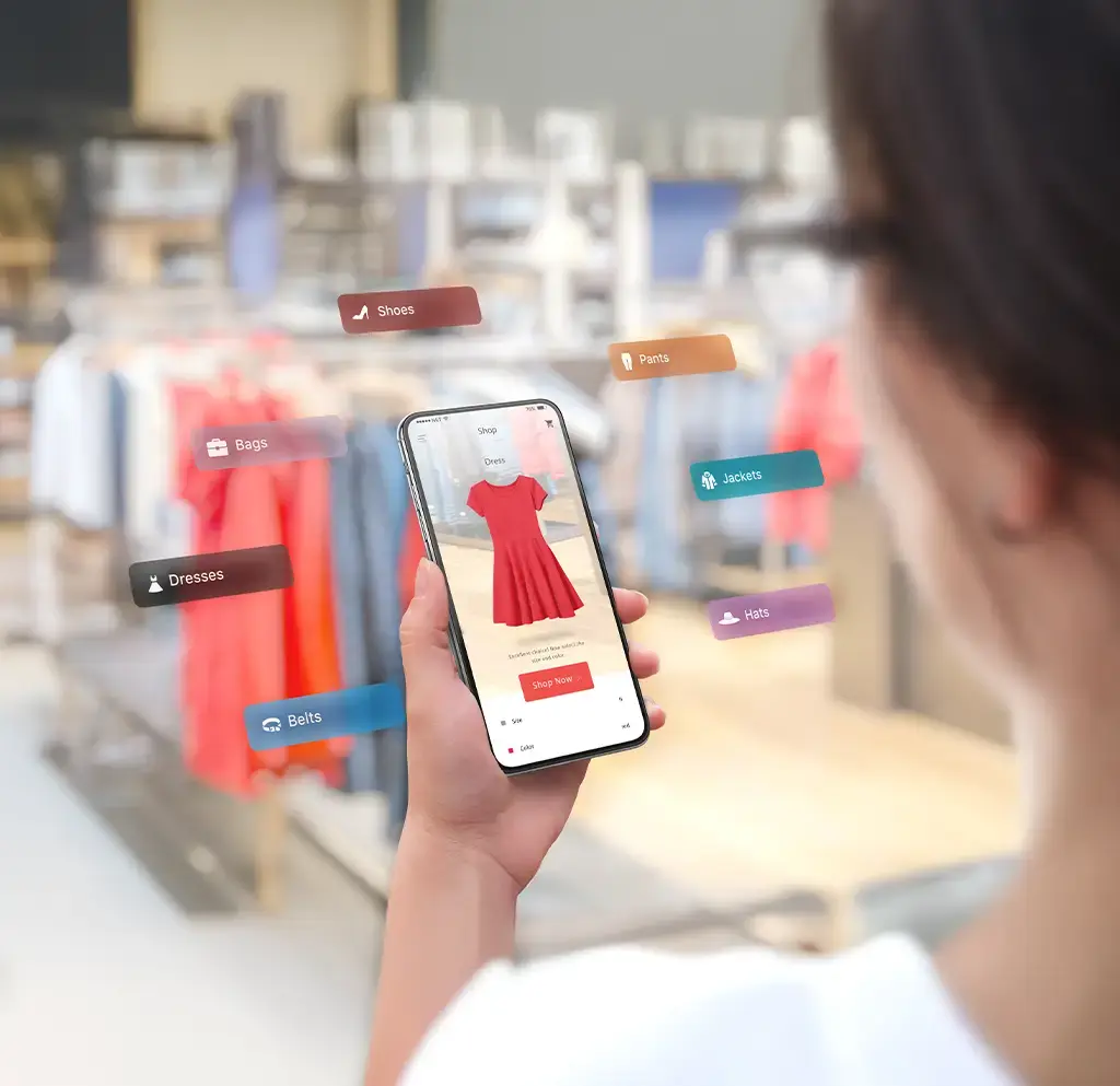 Person browsing digital clothing options on smartphone using augmented reality in retail store.