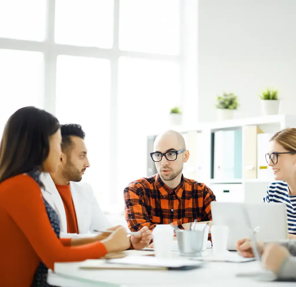 Team collaborating in a modern office space during a strategy or project planning meeting.