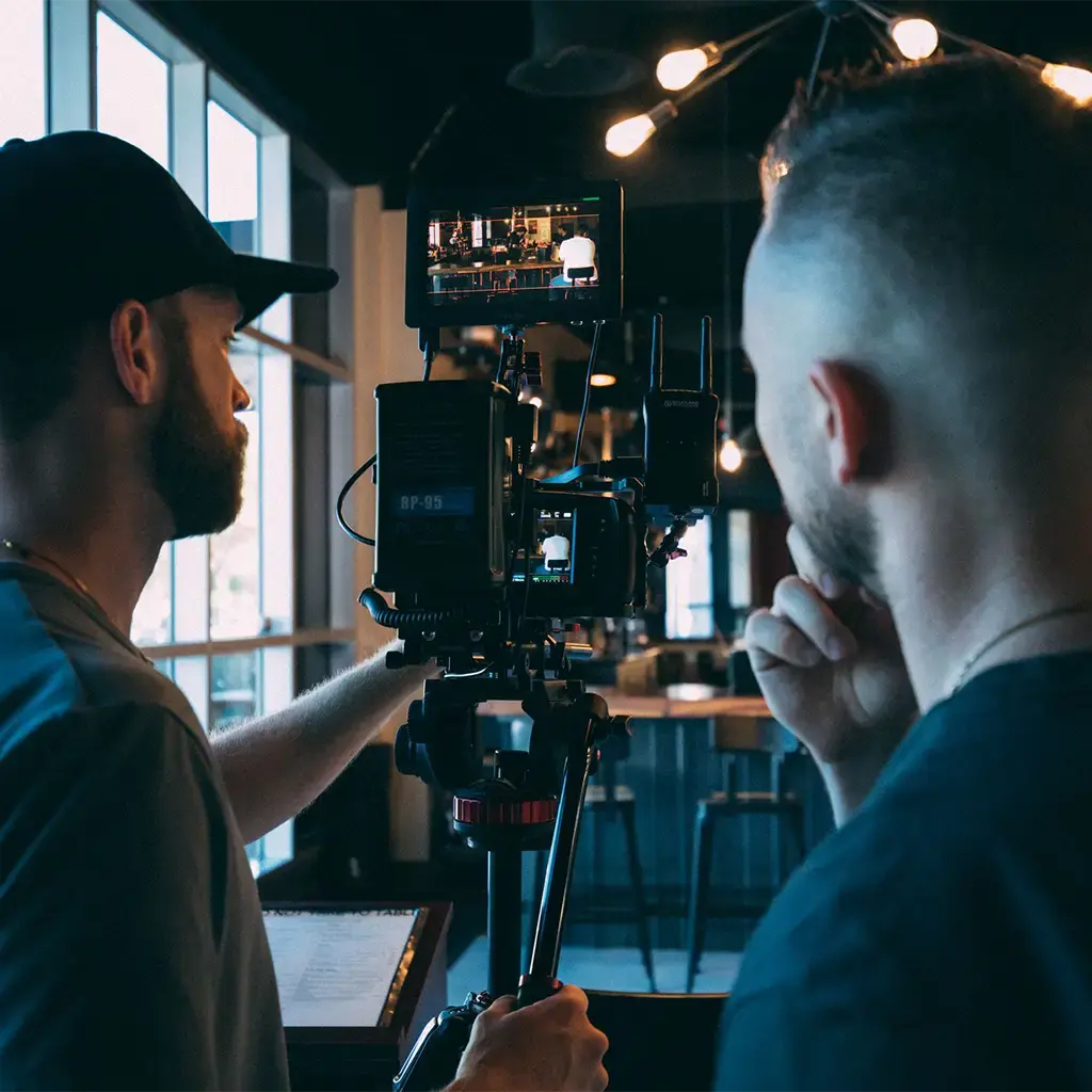 Film crew reviewing a camera shot during a media production