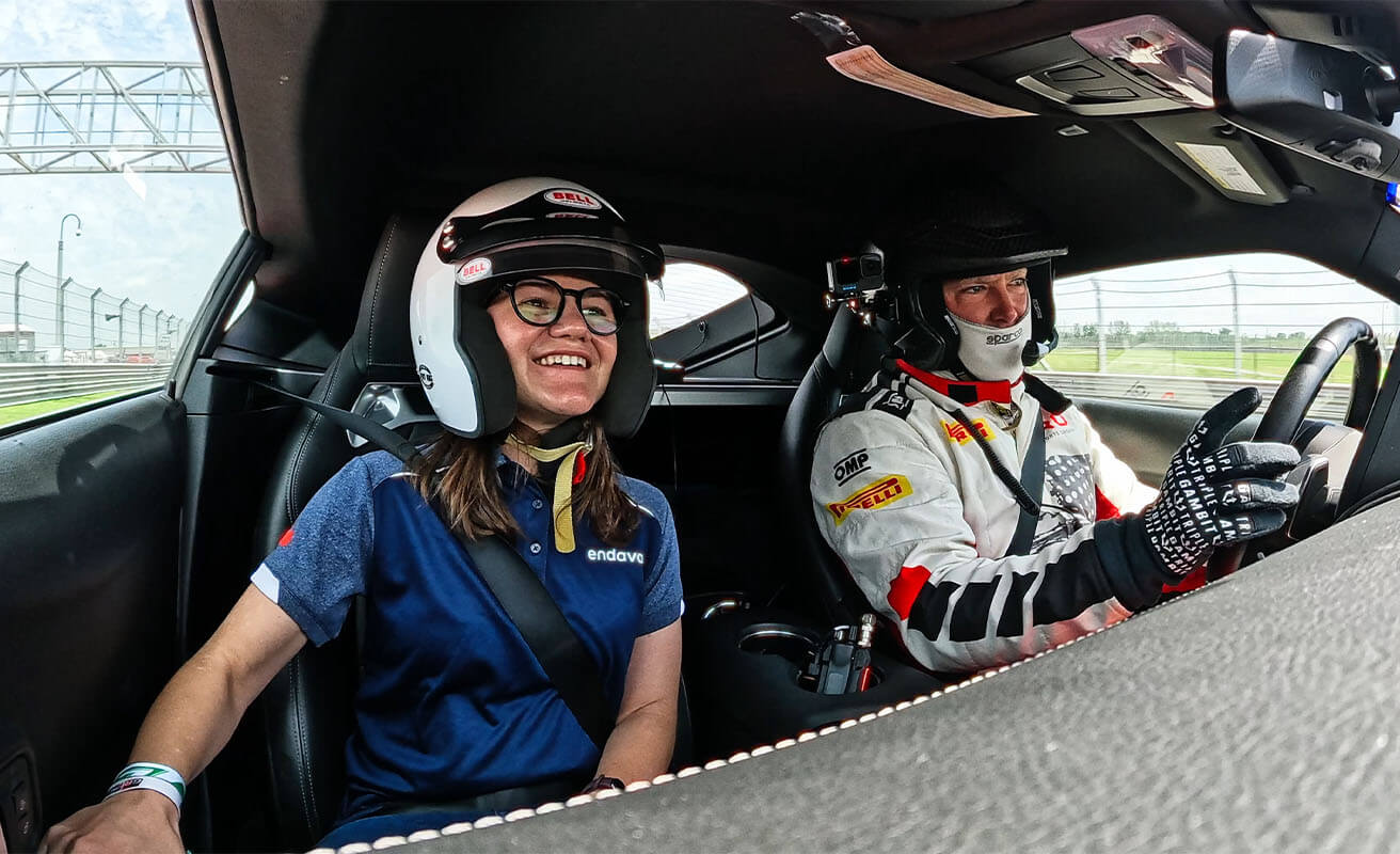 Endava team member experiences high-performance vehicle testing with professional driver on a race track