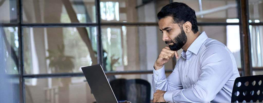 cyber security specialist looking at laptop