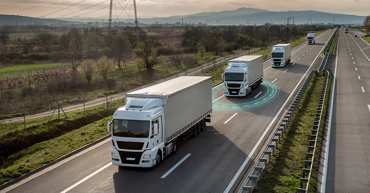 Trucks-driving-on-a highway-with-one-truck-showing-radar-detection-signals-on-a-sunny-day.
