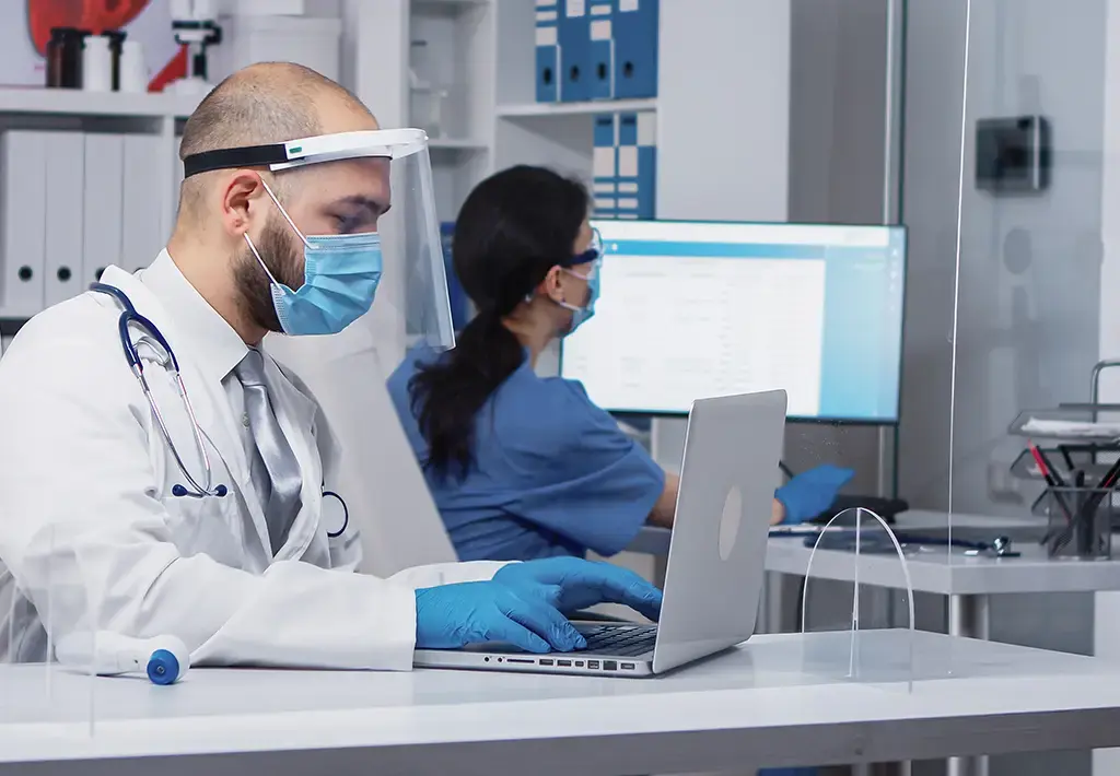 doctor-typing-on-laptop-carousel-insight-expanded