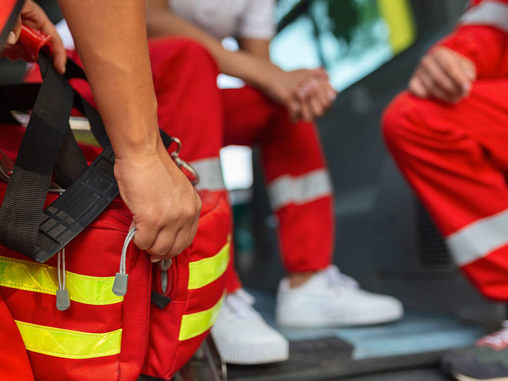 paramedics in the rear of an ambulance getting ready to respond to an emergancy call