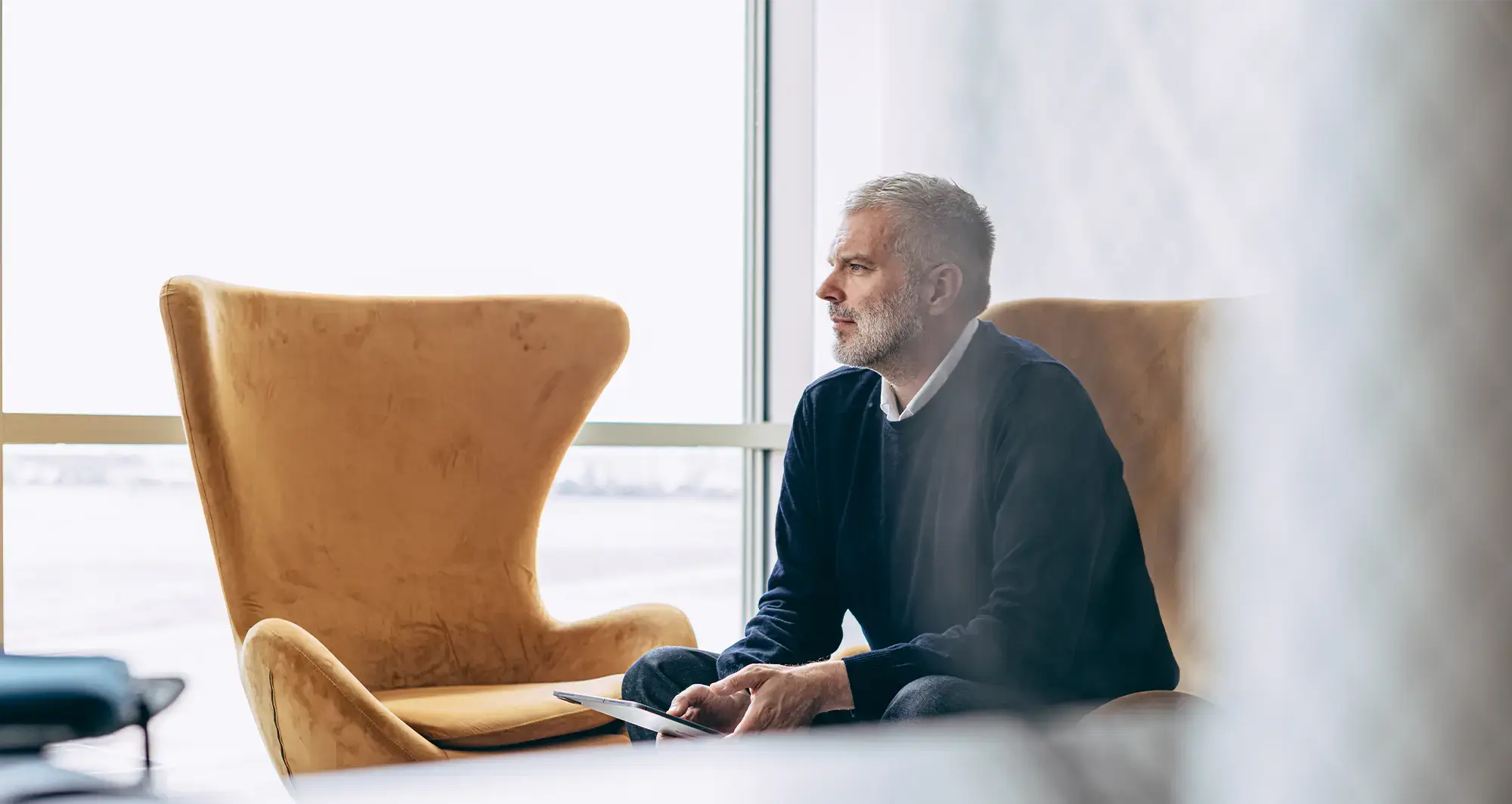 person-sitting-in-chair-with-tablet