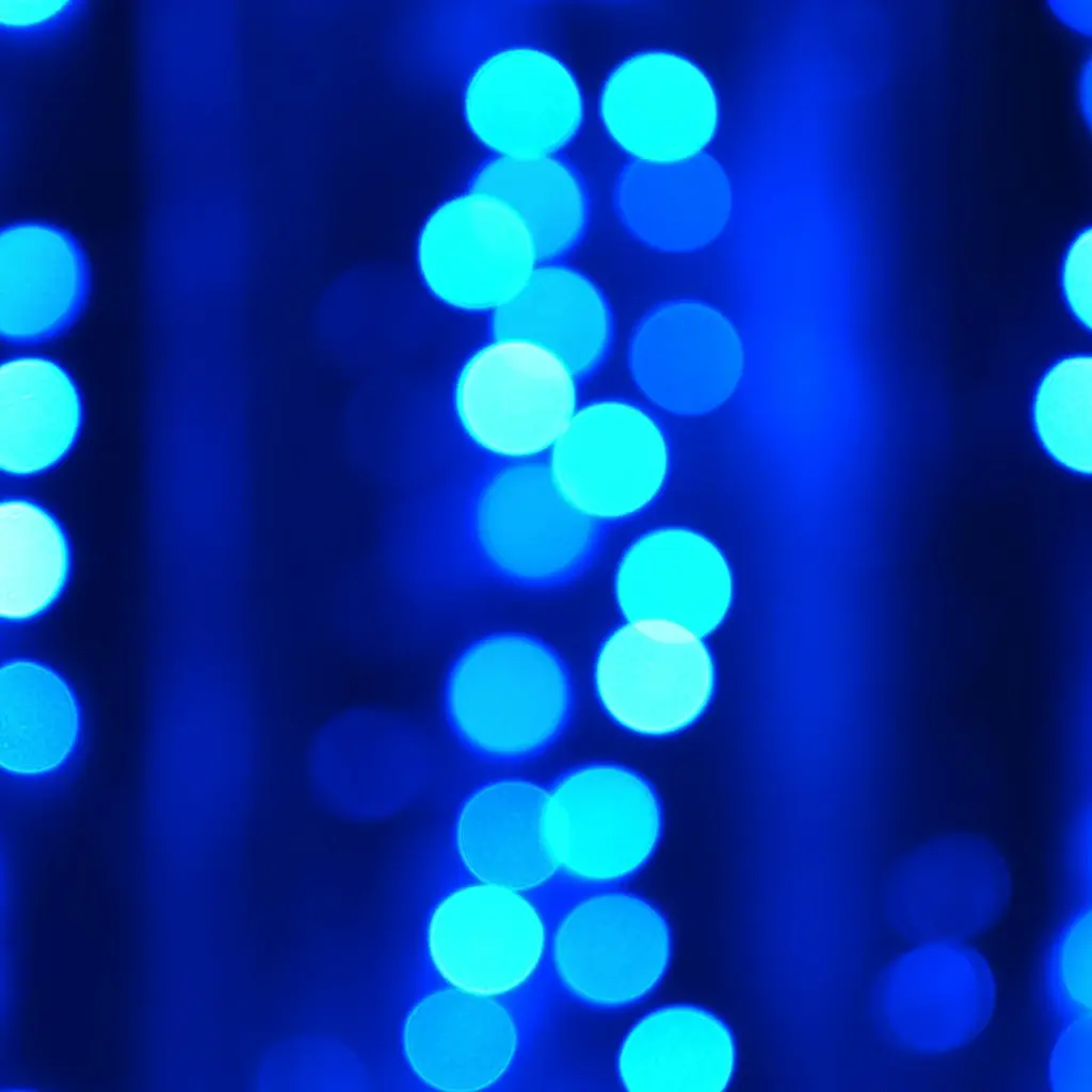 Abstract blue light dots forming vertical patterns, representing digital data flow and network connectivity