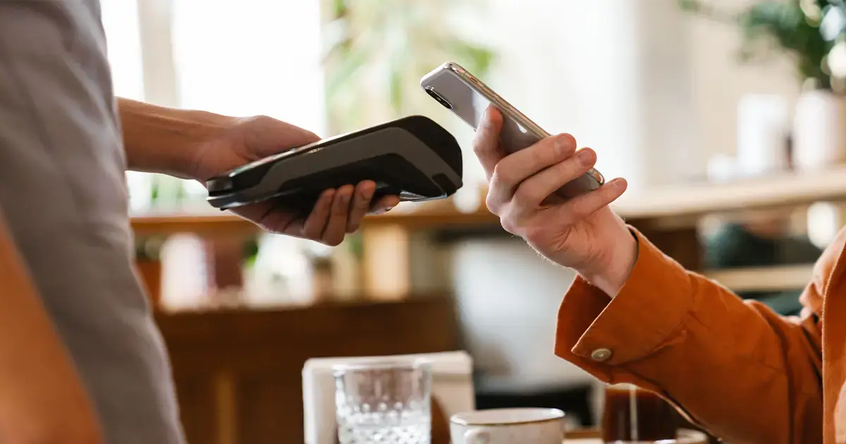young-man-paying-cafe-mobile--featured-image