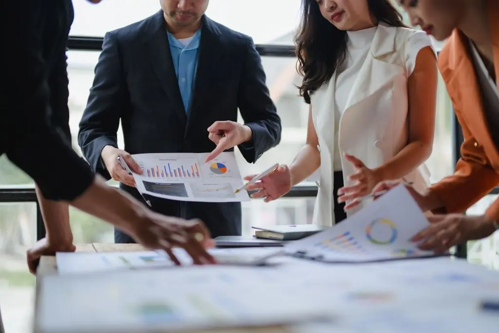 business-team-analyzing-financial-charts-and-graph-fullscreen-hero-desktop