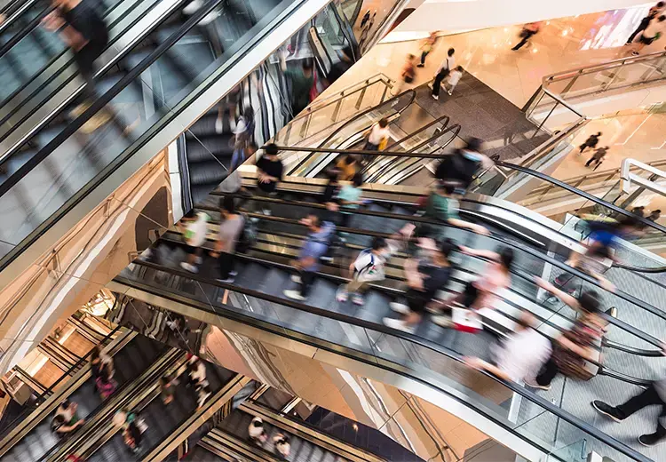 retail-customers-riding-the-escalors-in-shopping-mall-card