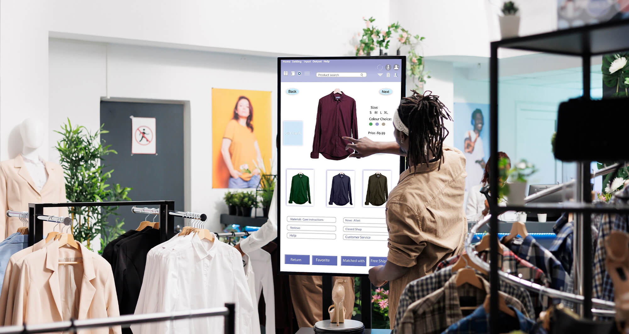 Customer using interactive touchscreen to browse clothing options in a retail store.