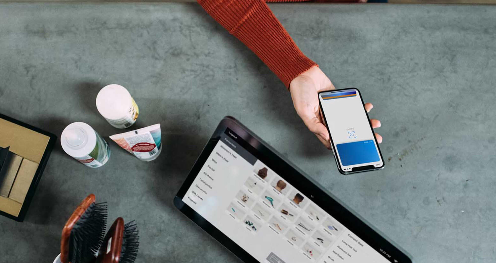 Customer using mobile wallet for payment at a digital point-of-sale terminal in a retail store.