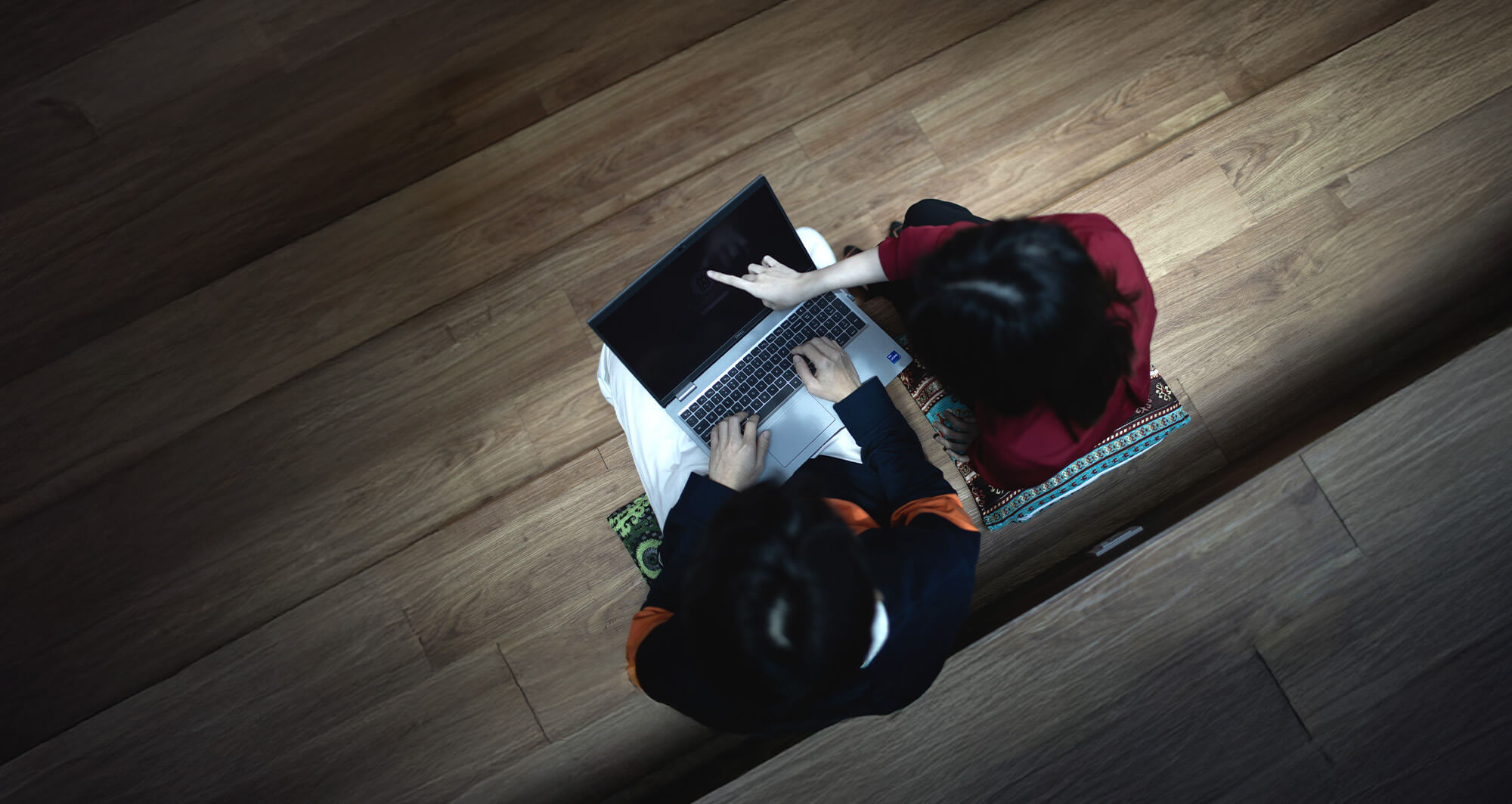 Two team members reviewing re-engagement strategies on a laptop in a collaborative workspace.