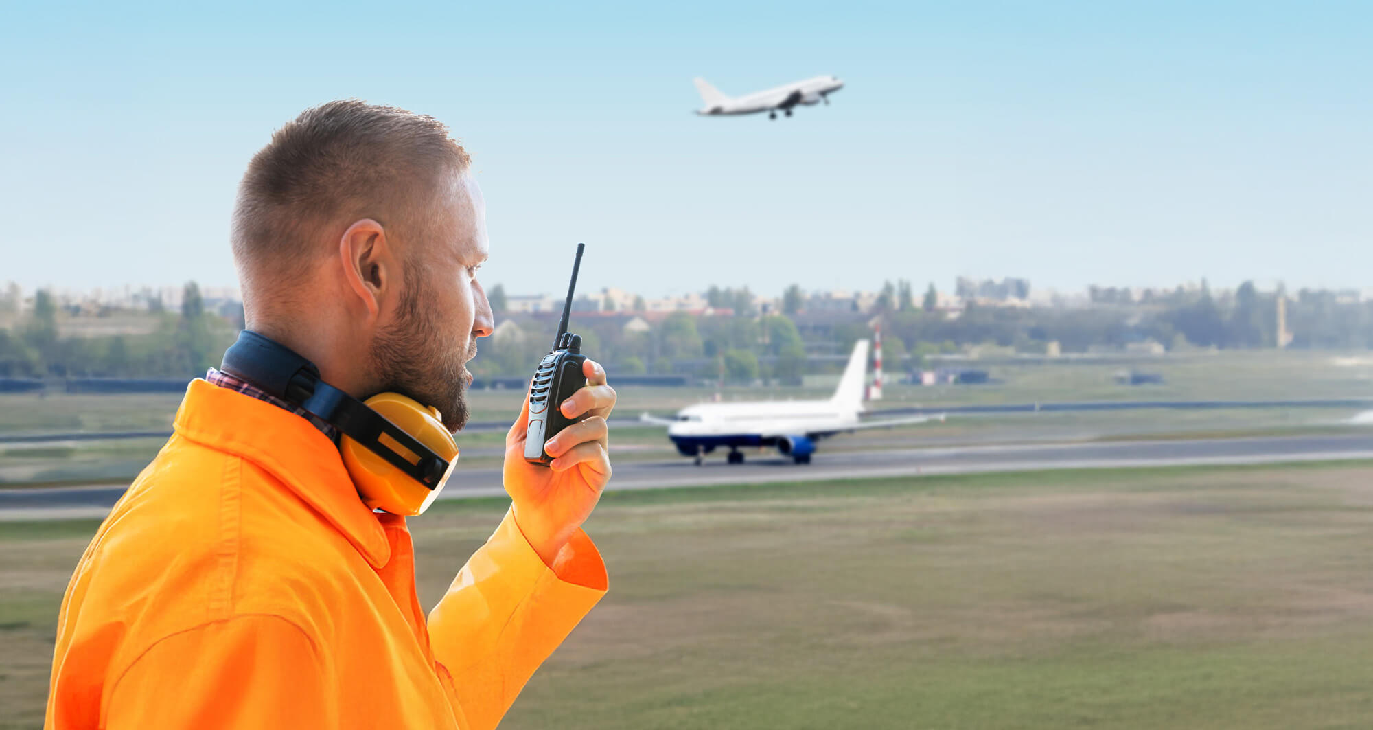 round crew member using radio at busy airport, highlighting need for digitalized operations.