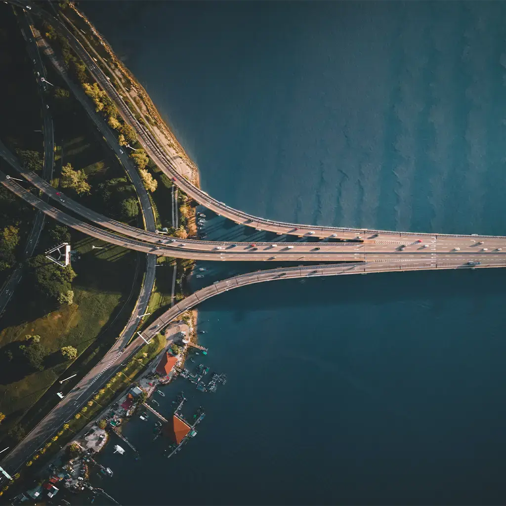 Aerial view of connected highways crossing water representing strategy