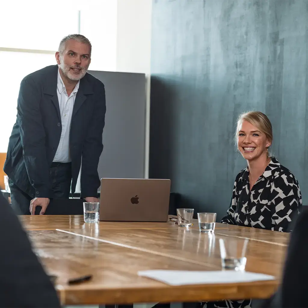 Business team discusses AI strategy and profitability in modern meeting room