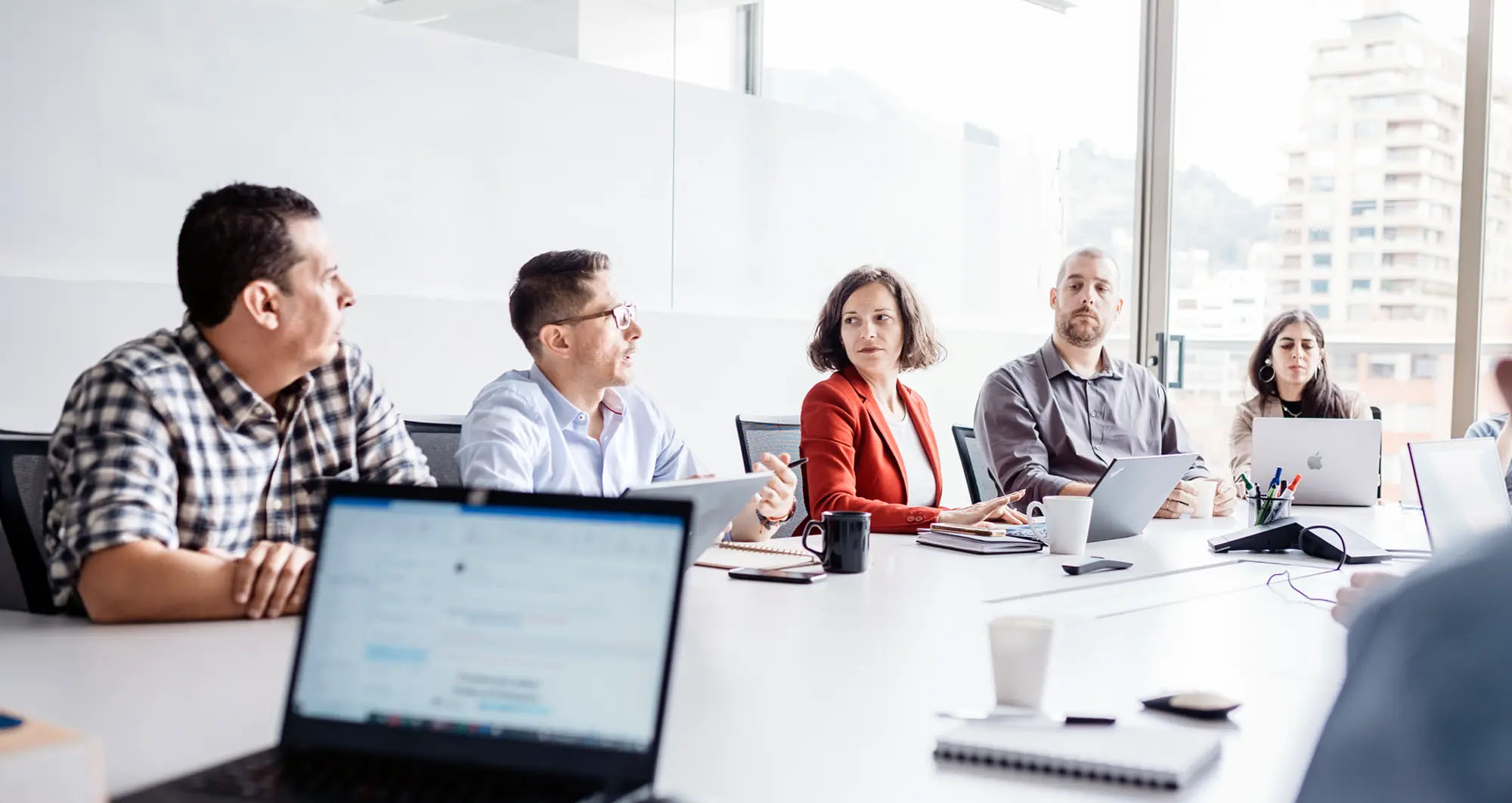 company leadership at a business table discussing plans