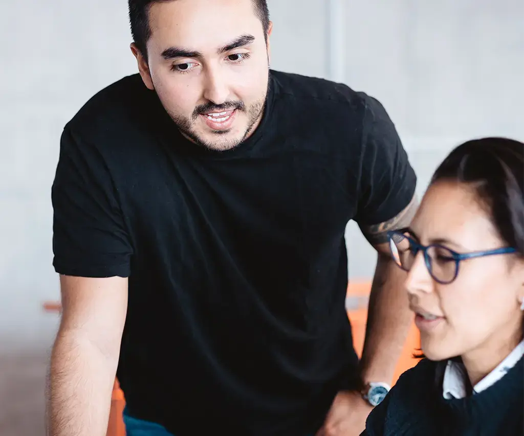 two endava coworkers reviewing work on computer