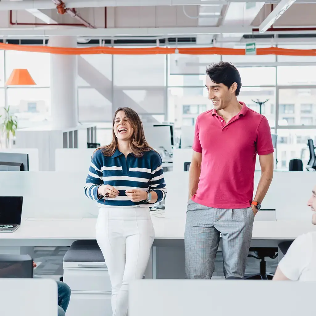 Team collaborating in a modern Endava Americas office with open desks and bright natural light
