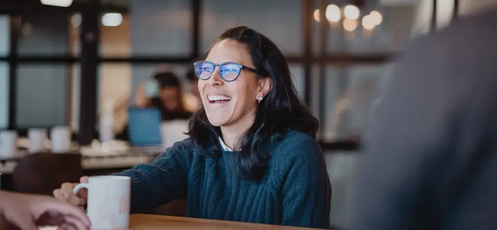 experienced professional enjoying a cup of coffee with coworkers