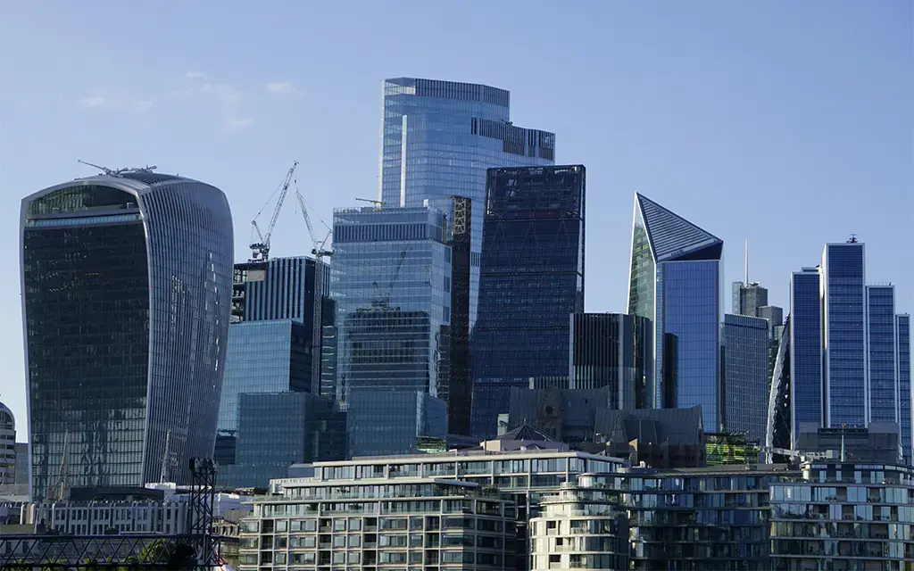 Glass high-rise offices in central London, highlighting technology-led change for banking and capital markets.