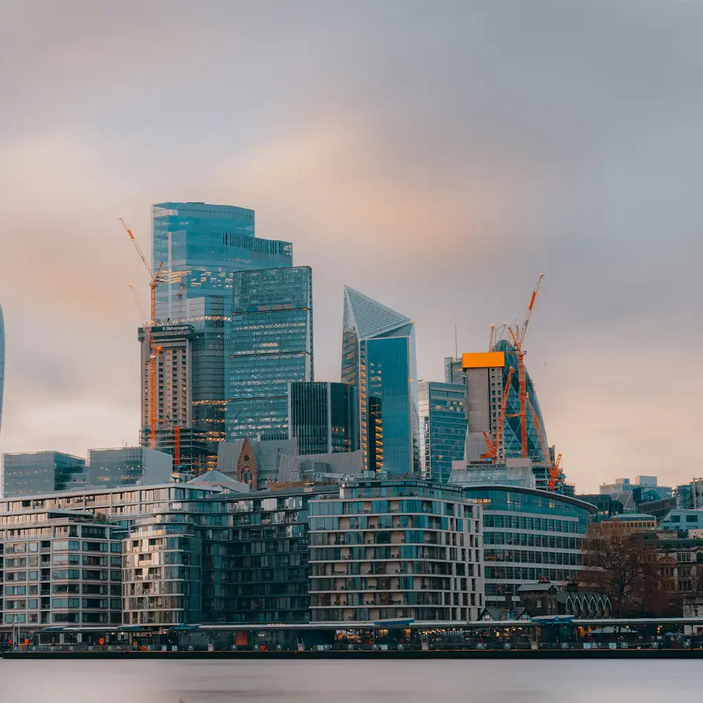 London financial district skyline at dusk, reflecting on the Thames, symbolizing digital transformation and enterprise growth.