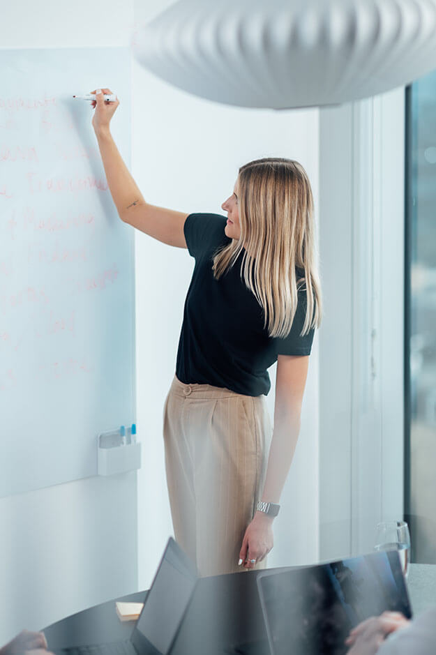 Professional leading a whiteboard planning session for digital strategy and business transformation