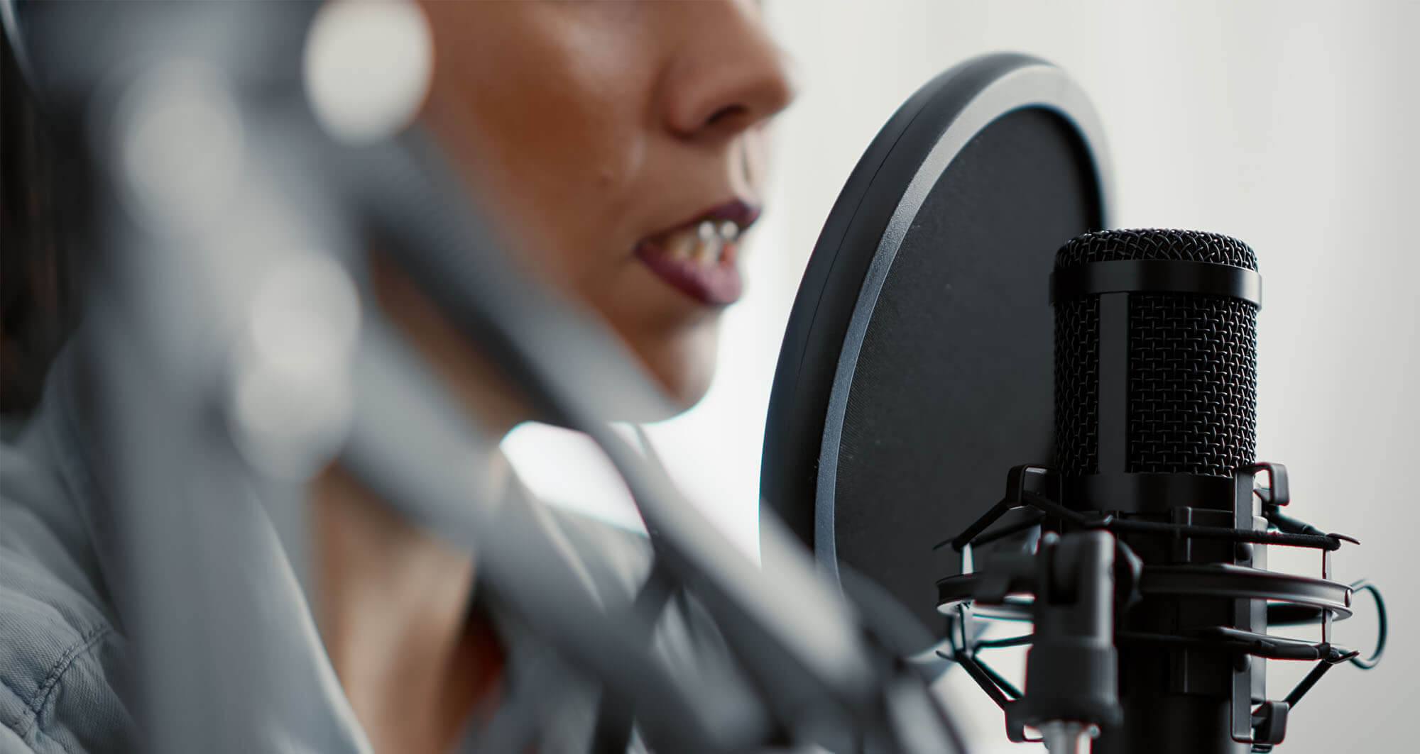 woman speaking into podcast microphone