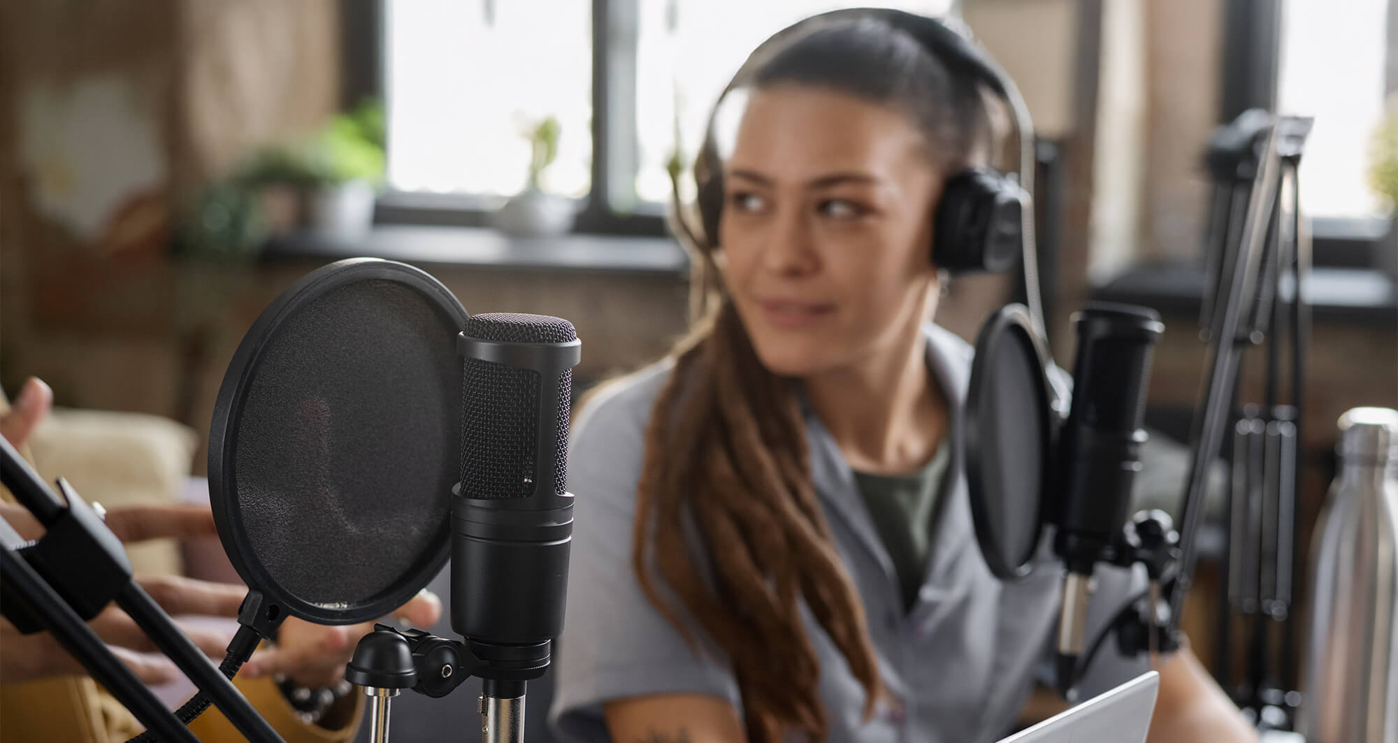 woman smiling at podcaster at her side