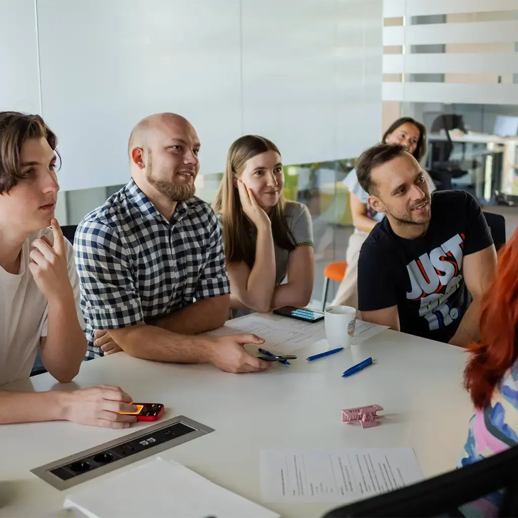 Participants in a software development workshop at Dava.X Academy working together around a screen