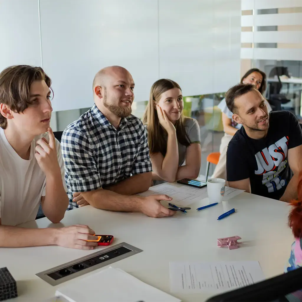 Participants in a software development workshop at Dava.X Academy working together around a screen