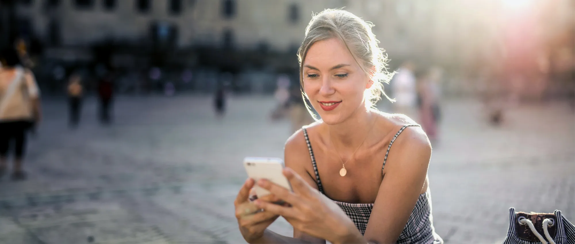 Woman looking at iVie app on cell phone.