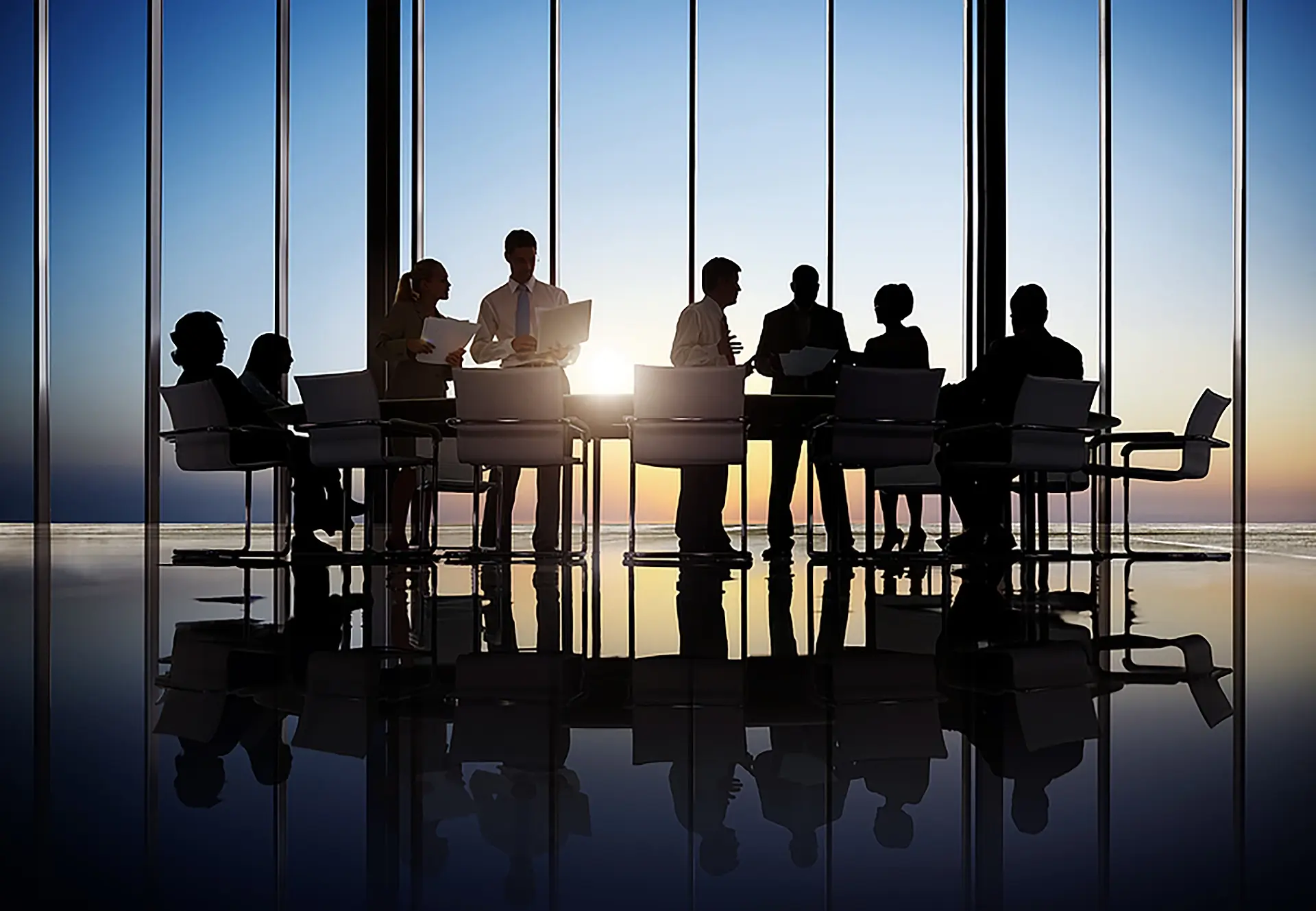 Business professionals in a meeting room silhouetted against the light, discussing Agentic AI