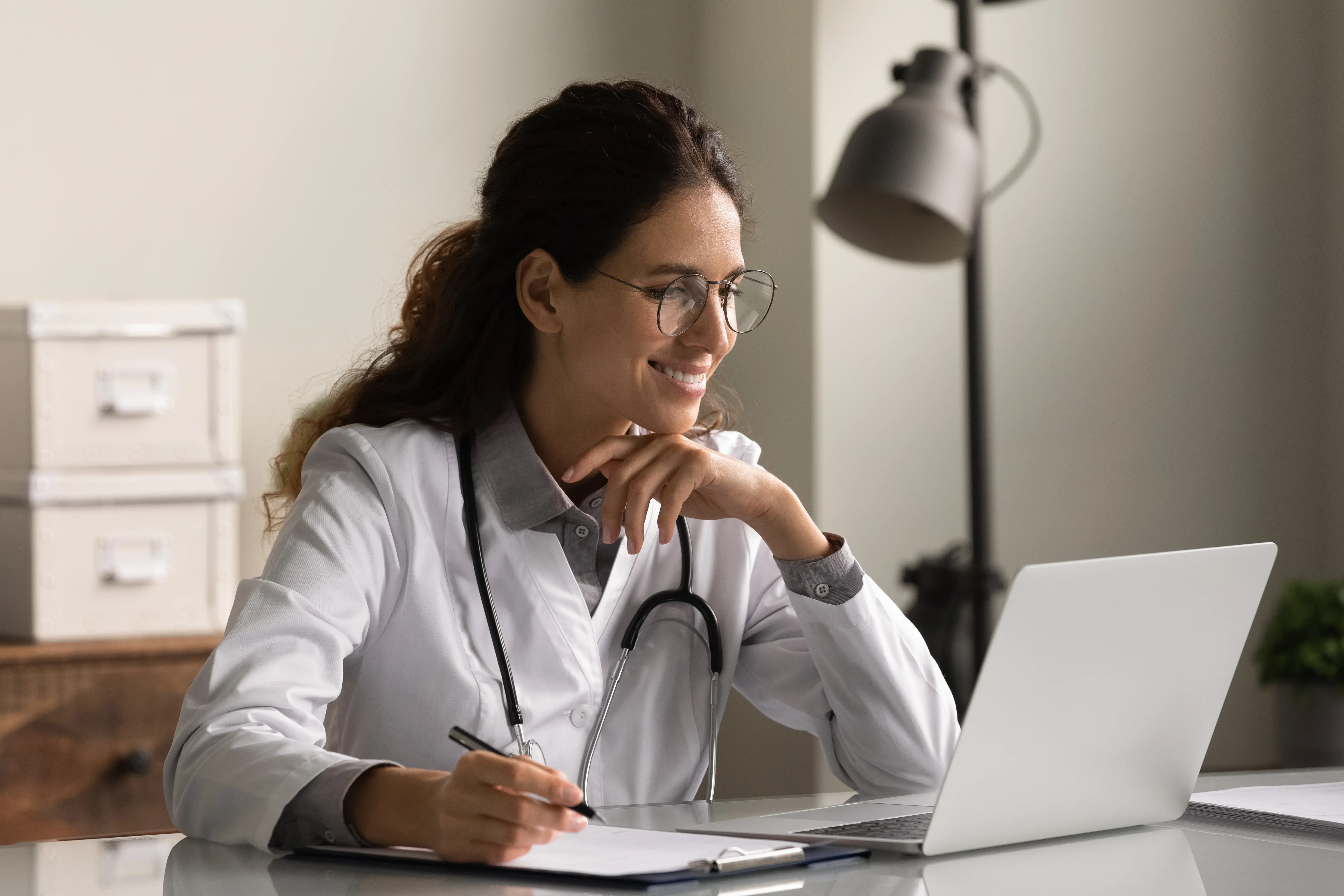 Female doctor using laptop, exploring FAIR Principles in healthcare data.