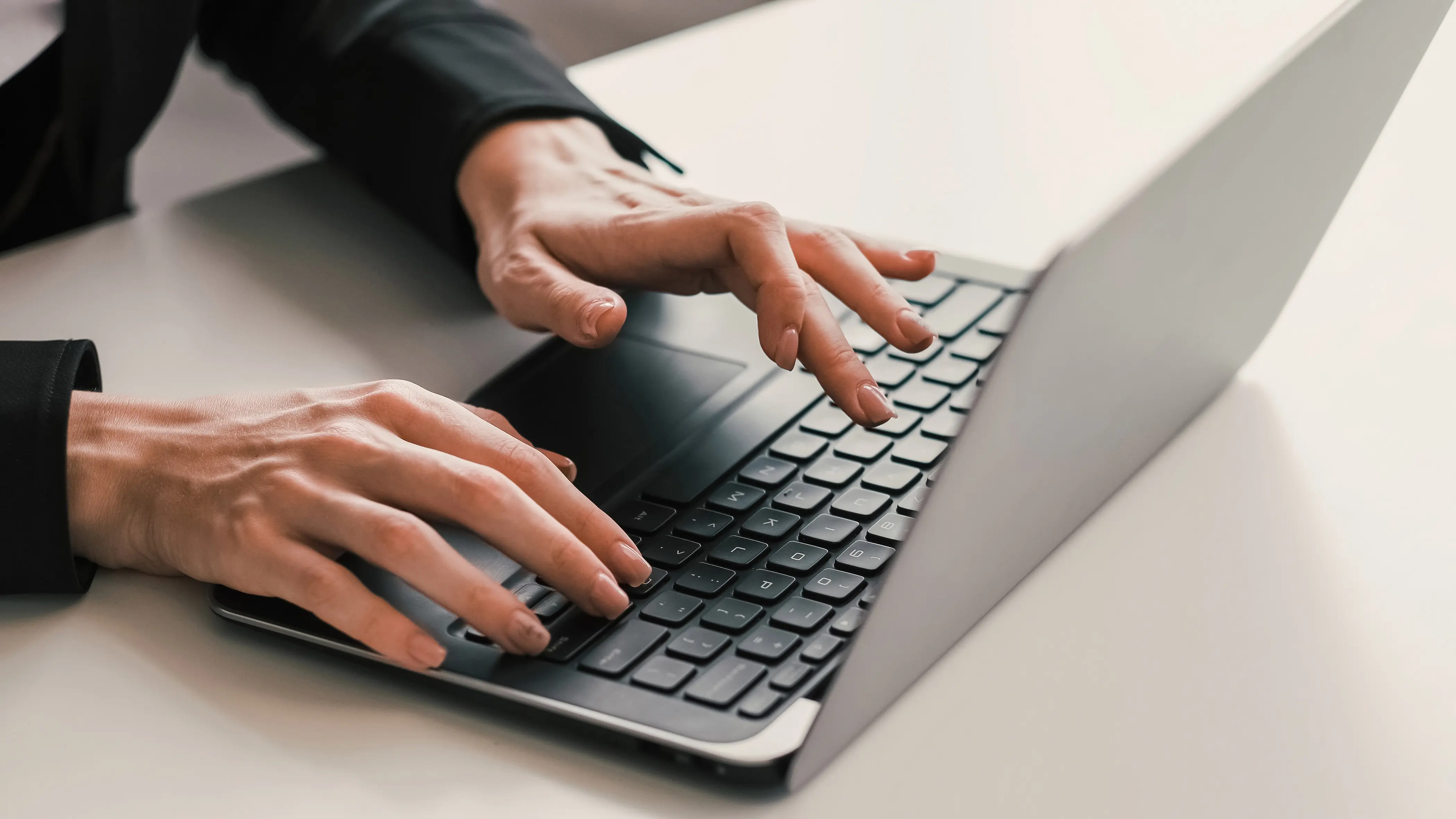 A person typing on a laptop exploring the AI infrastructure landscape.