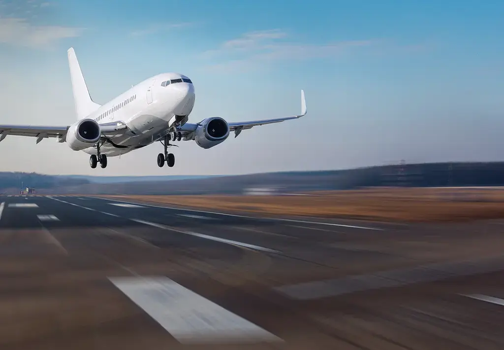 Commercial airplane taking off from runway, symbolizing global travel and transportation technology.