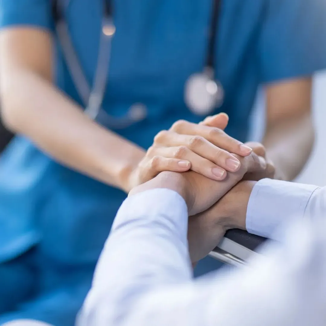 A medical professional is assisting a patient