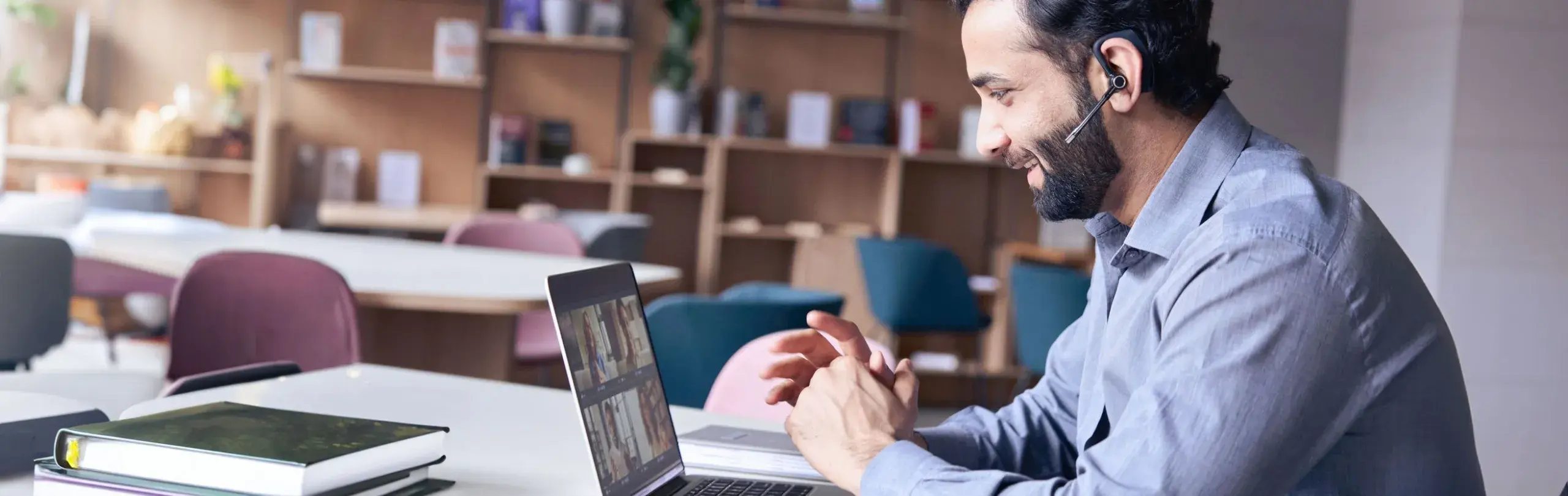 Man having a videoconference throw his notebook