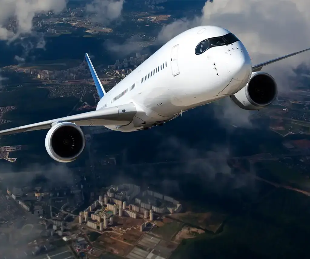 Commercial airplane flying above a cityscape, highlighting aviation technology and travel innovation.
