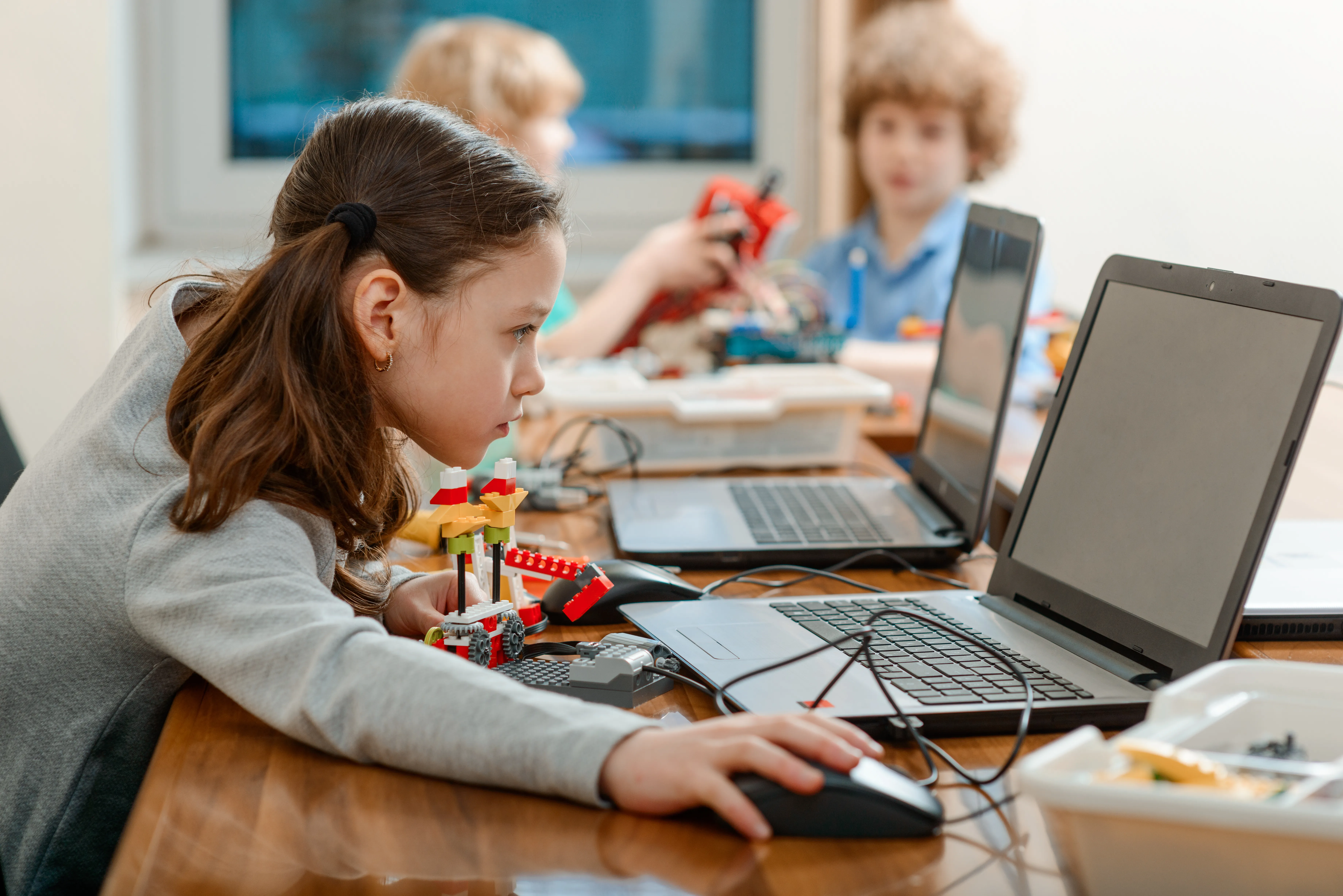 A group of children sitting around a table, working creatively.