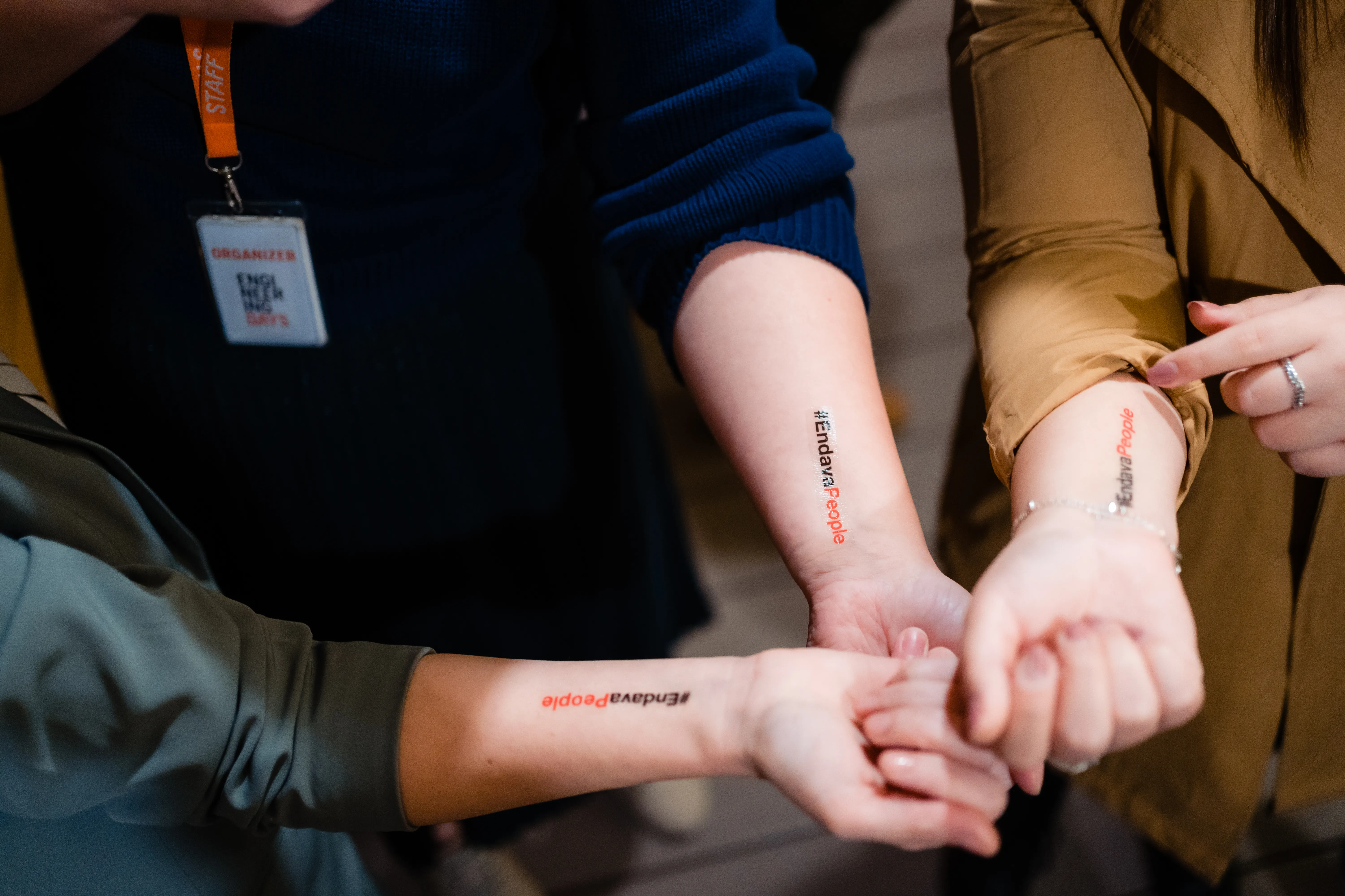 People showing their stick on arm tattoos.