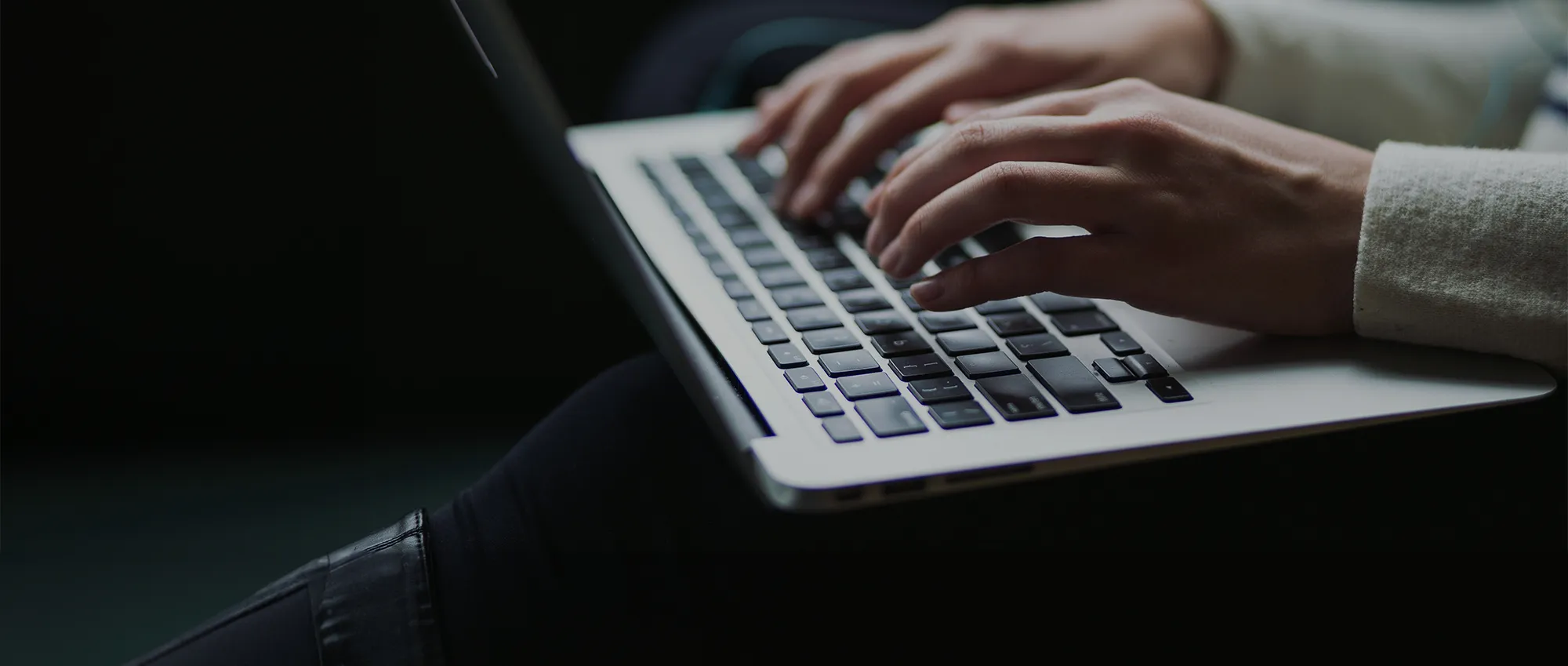 A person is typing on a laptop.