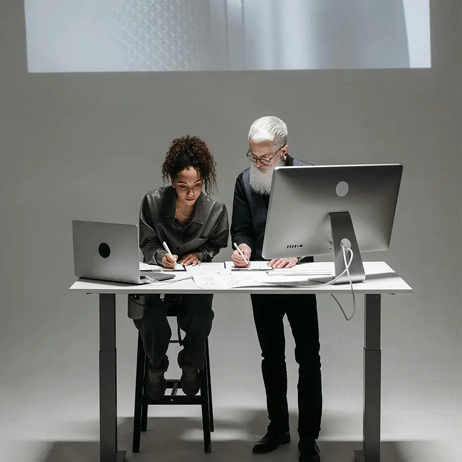 Team collaborating on AI-driven design at a modern workstation with digital tools