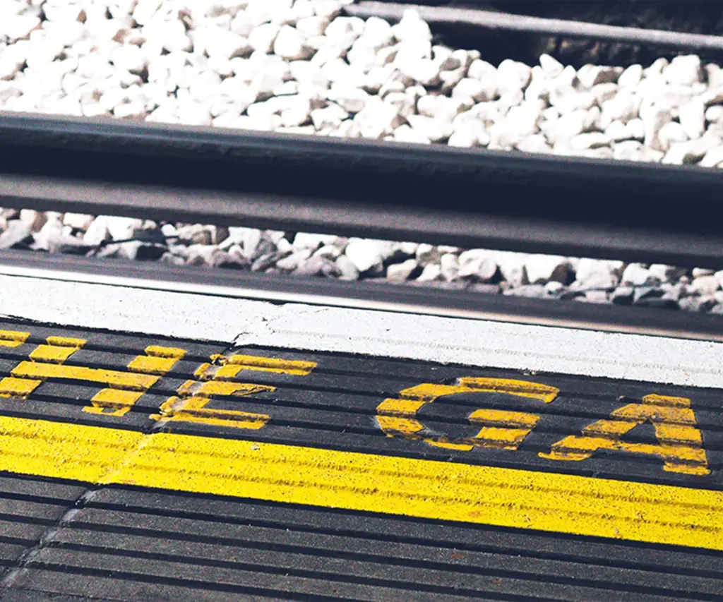 Yellow text next to railroad tracks