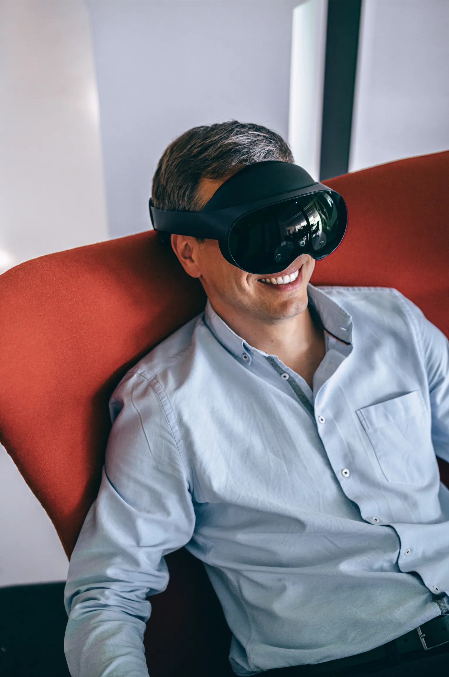 A man sitting in a chair wearing a VR headset.